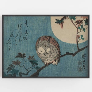 May include: A woodblock print of an owl perched on a branch with a full moon in the background. The owl is brown and gray with its eyes closed. The branch is bare except for a few leaves. The moon is a pale yellow and the background is a light blue. The print is signed in Japanese characters.