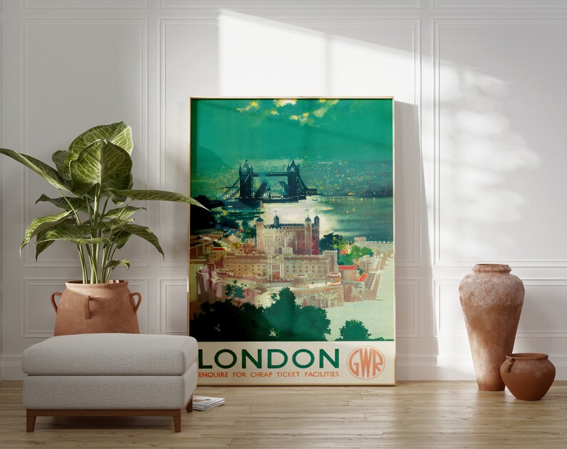 May include: Vintage travel poster featuring a colorful illustration of Tower Bridge in London, England. The poster has a green background with the text "LONDON GWR ENQUIRE FOR CHEAP TICKET FACILITIES".