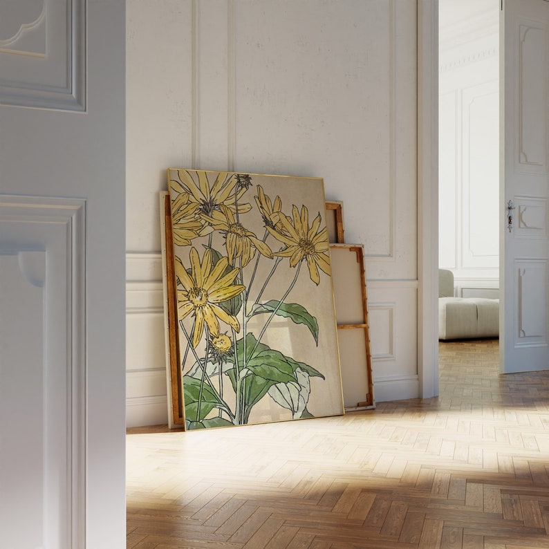 May include: A framed print of a botanical illustration featuring yellow flowers with green leaves on a beige background.