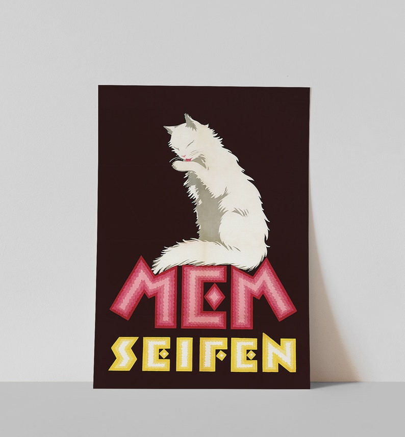 May include: A poster featuring a white cat grooming itself, set against a dark maroon background. The poster includes the text "MEM SEIFEN" in pink and yellow, with a decorative, geometric font. The cat is the central focus.