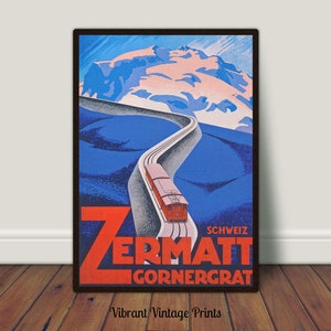 May include: Vintage travel poster for Zermatt, Switzerland, featuring a red train ascending a winding track towards a snow-capped mountain. The poster has a blue and red color scheme with the text "Zermatt Gornergrat".