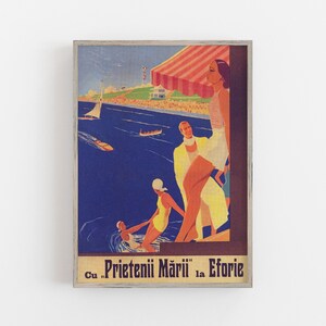 May include: Vintage travel poster print featuring a seaside scene with people in swimwear, boats, and a beach. The poster has a wooden frame and includes text in the lower portion. The color palette includes blues, yellows, and reds.