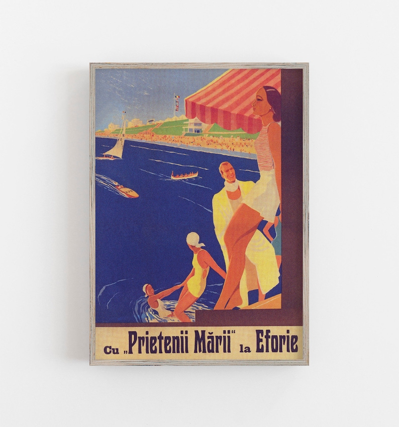 May include: Vintage travel poster print featuring a seaside scene with people in swimwear, boats, and a beach. The poster has a wooden frame and includes text in the lower portion. The color palette includes blues, yellows, and reds.