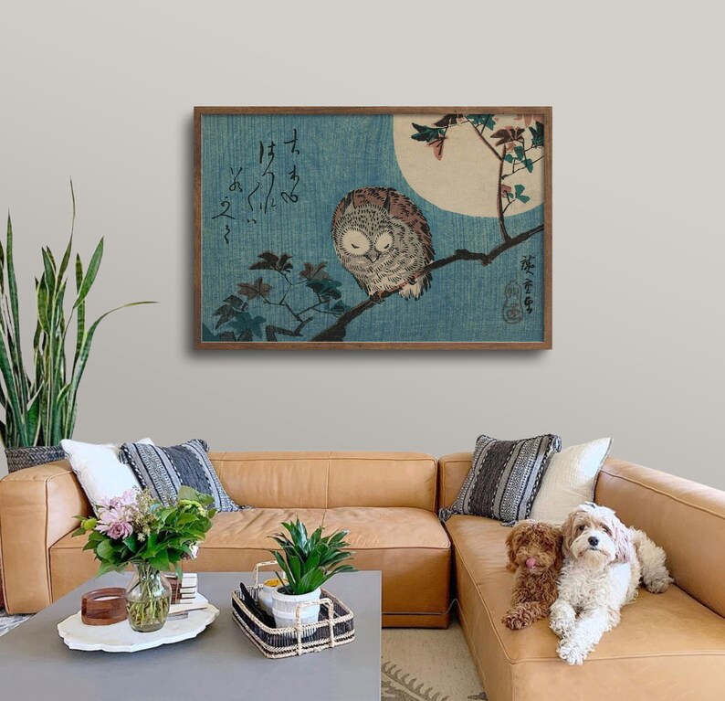 May include: A framed print of a Japanese woodblock print depicting an owl perched on a branch with a full moon in the background. The print is in shades of blue, green, and brown. The Japanese text in the print reads "I hear the owl's cry."