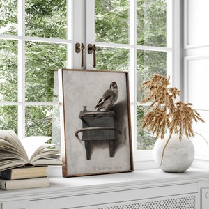 May include: A framed painting of a bird perched on a wooden object. The painting is in a brown frame and has a white background. The bird is brown and white and has a long tail. The painting is titled "C. Fabritius 1654".