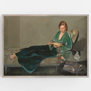 May include: A painting of a woman in a green velvet robe sitting on a chaise lounge and reading a book. The woman has red hair and is wearing a green velvet robe. The chaise lounge is covered in a white fabric. The painting is set in a room with a light brown wall and a white ceiling.