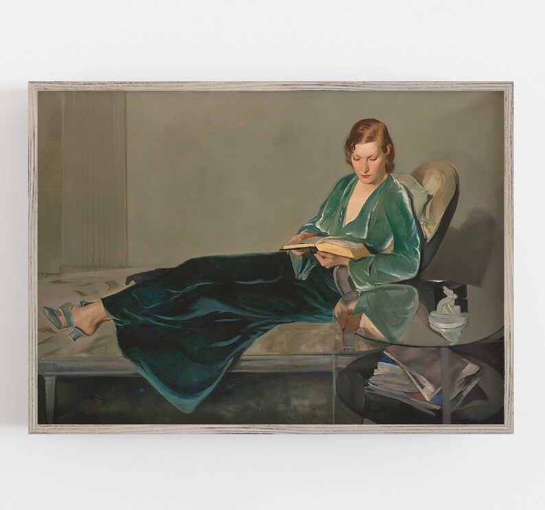May include: A painting of a woman in a green velvet robe sitting on a chaise lounge and reading a book. The woman has red hair and is wearing a green velvet robe. The chaise lounge is covered in a white fabric. The painting is set in a room with a light brown wall and a white ceiling.