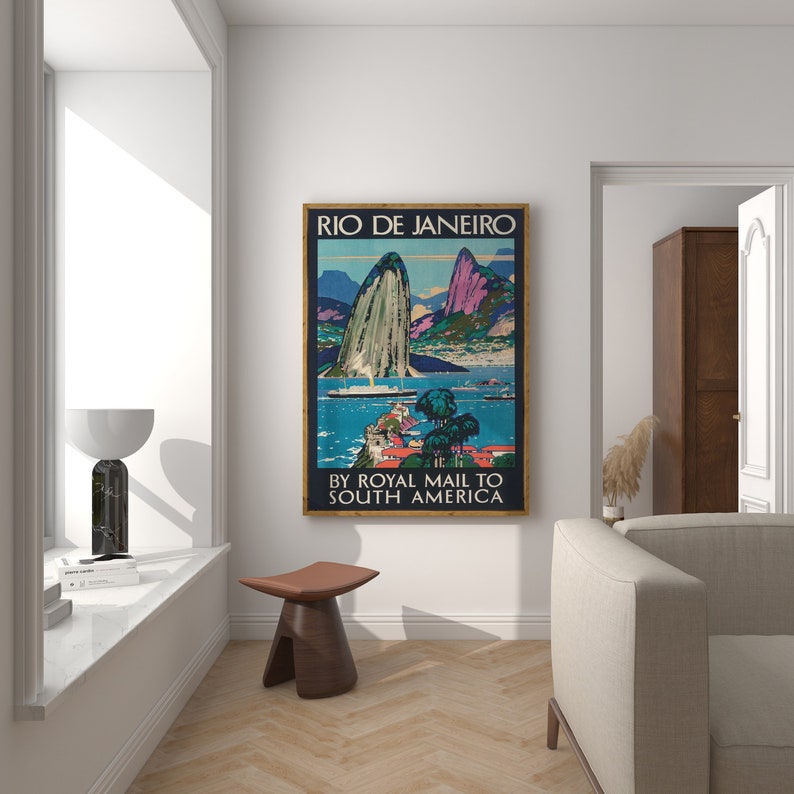 May include: Vintage travel poster advertising a trip to Rio de Janeiro by Royal Mail to South America. The poster features a colorful illustration of Sugarloaf Mountain and Guanabara Bay.