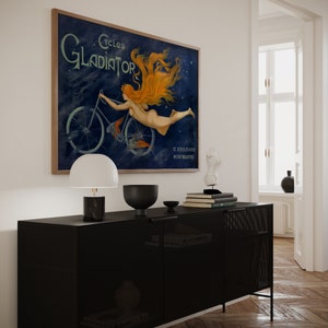 May include: A vintage poster advertising Cycles Gladiator, a bicycle brand. The poster features a woman with flowing red hair riding a bicycle against a blue starry background. The text "Cycles Gladiator" is in a bold, decorative font. The poster also includes the address "12, Boulevard Montmartre".