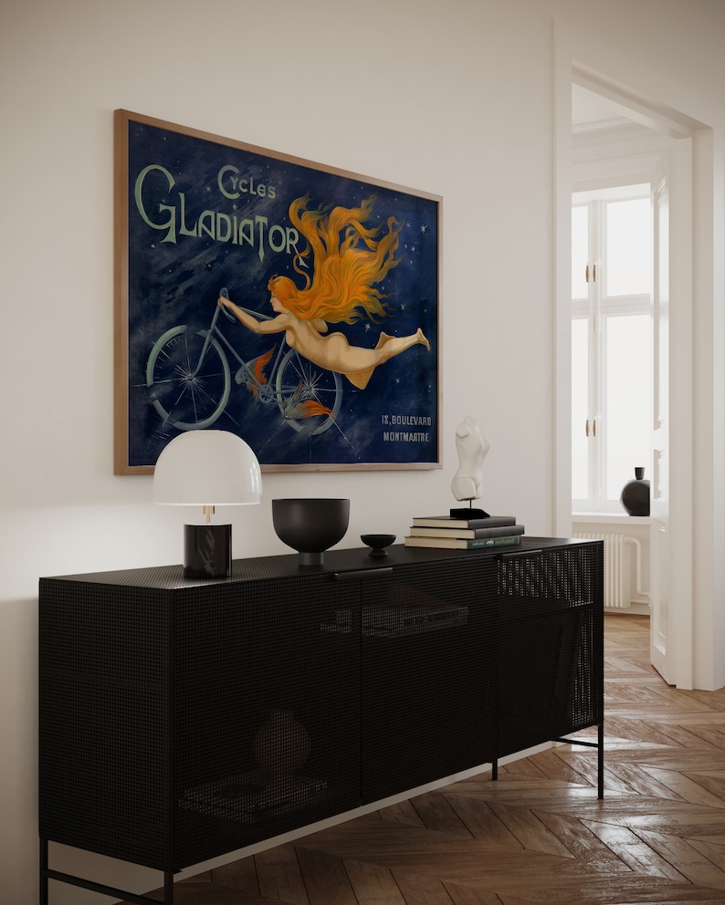 May include: A vintage poster advertising Cycles Gladiator, a bicycle brand. The poster features a woman with flowing red hair riding a bicycle against a blue starry background. The text "Cycles Gladiator" is in a bold, decorative font. The poster also includes the address "12, Boulevard Montmartre".