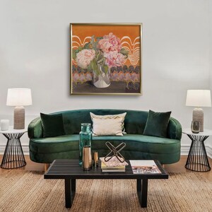 May include: A green velvet sofa with a floral painting above it. The painting features pink peonies in a clear glass vase on a table with an orange background. The sofa has a white throw pillow and a green throw pillow.