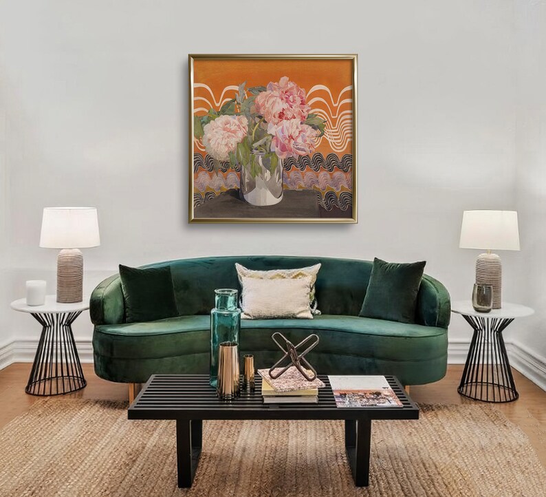 May include: A green velvet sofa with a floral painting above it. The painting features pink peonies in a clear glass vase on a table with an orange background. The sofa has a white throw pillow and a green throw pillow.