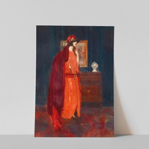 May include: A woman in a red dress and a red hat stands in a room with a dark blue wall. She is wearing a long, flowing red cloak and has a thoughtful expression on her face. The room is decorated with a dark wooden dresser and a framed picture.