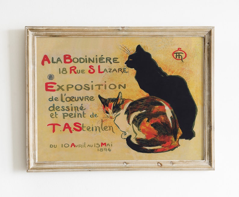 May include: Framed vintage poster featuring two cats, one black and one calico, with text in red and green. The poster advertises an exhibition of work by T.A. Steinlen, with the dates April 10 to May 15, 1894.