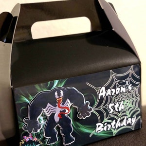 May include: A black and green favor box with a Venom character graphic and the text "Aaaron's 5th Birthday" on the front.
