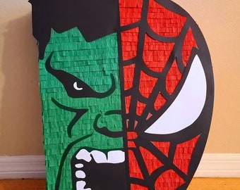 May include: A green and red pinata shaped like the faces of Hulk and Spiderman. The pinata is made of tissue paper and has a black outline.