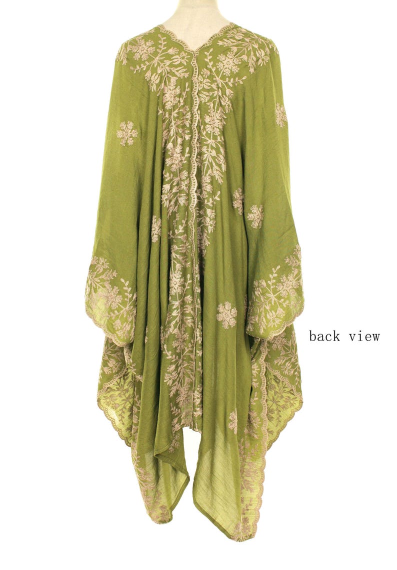 May include: Olive green embroidered tunic with a V-neck and wide sleeves. The tunic features intricate floral embroidery in a contrasting beige color, with the words "back view" visible.