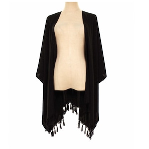 May include: A solid black open-front kimono featuring wide sleeves and a hemline adorned with decorative black tassels. The garment is displayed on a mannequin, showcasing a lightweight, flowing fabric with a straight, relaxed silhouette.
