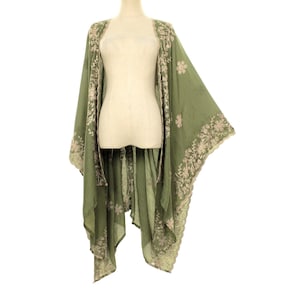 May include: Olive green kimono-style cover-up with floral embroidery. The open-front garment features long sleeves and a flowing silhouette. The embroidery is in a contrasting light beige color, adding detail to the lightweight fabric.