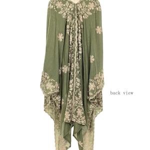 May include: Olive green embroidered tunic with a flowing silhouette. The tunic features intricate floral embroidery in a contrasting beige color along the edges, sleeves, and center panel. The back view is shown, highlighting the design details.