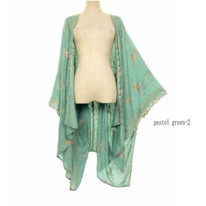 May include: A pastel green kimono-style garment with floral embroidery and scalloped edges. The open-front design features long, flowing sleeves and a delicate, airy fabric. The text "pastel green-2" is visible.