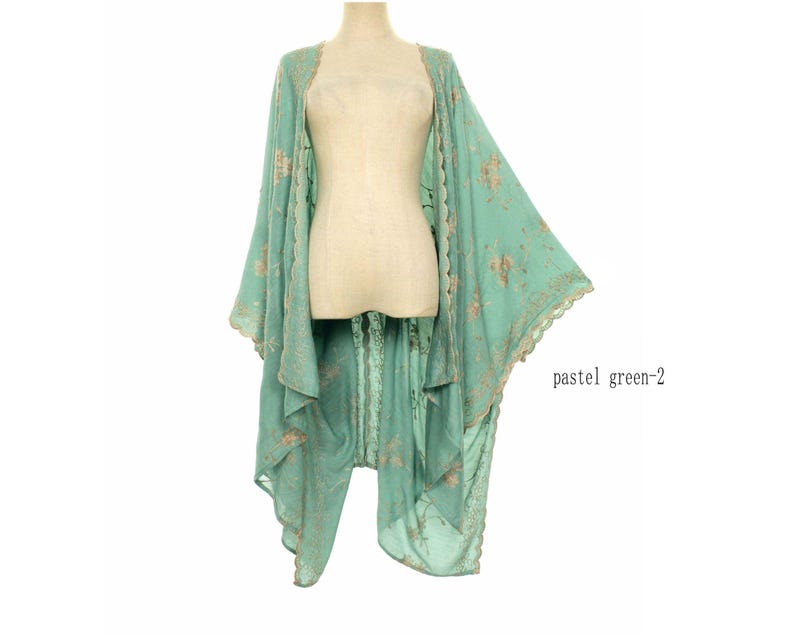 May include: A pastel green kimono-style garment with floral embroidery and scalloped edges. The open-front design features long, flowing sleeves and a delicate, airy fabric. The text "pastel green-2" is visible.