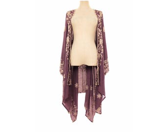 May include: A deep purple open-front kimono featuring long, flowing sleeves and a light beige floral embroidery pattern along the front edges and hemline. The garment has a loose, draped silhouette with a lightweight, semi-sheer fabric construction.