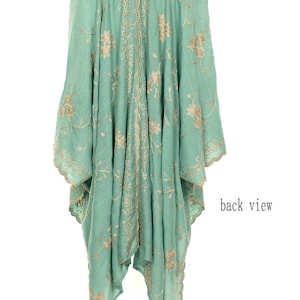 May include: A flowing, mint green garment with intricate gold floral embroidery. The back view reveals a detailed design along the center and edges, with the words "back view" visible on the right side. The fabric appears lightweight and airy.