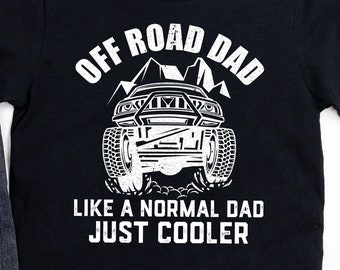 May include: Black t-shirt with white text that reads "Off Road Dad Like a Normal Dad Just Cooler". The shirt features a white silhouette of an off-road vehicle with mountains in the background.