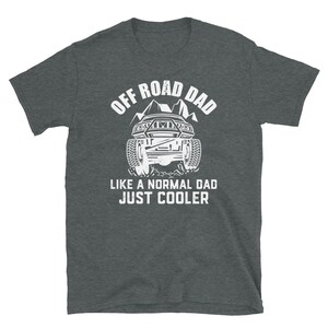 May include: A dark heather grey t-shirt with a white graphic of an off-road vehicle and the text "Off Road Dad Like a Normal Dad Just Cooler".