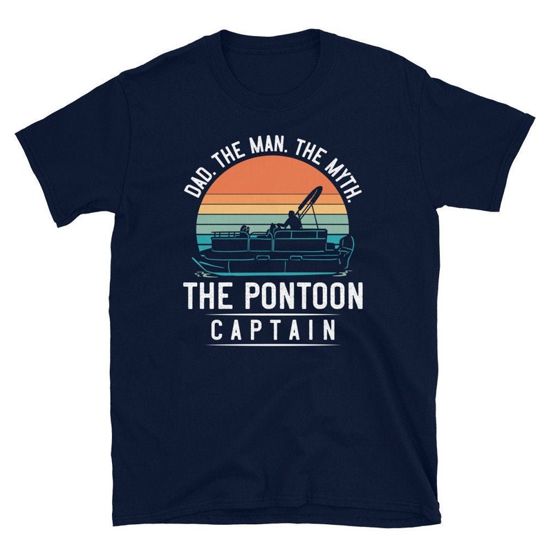 May include: A navy blue t-shirt with a vintage-style graphic of a pontoon boat on a sunset background. The text reads "Dad. The Man. The Myth. The Pontoon Captain."