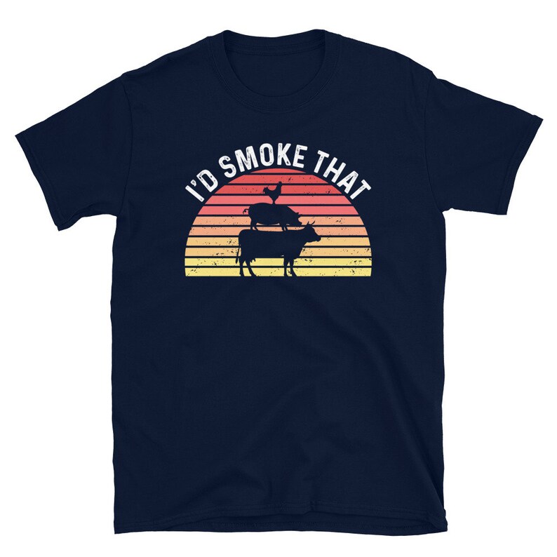 May include: Navy blue t-shirt with a retro sunset graphic and the text "I'd Smoke That". The graphic features a chicken, pig, and cow stacked on top of each other.