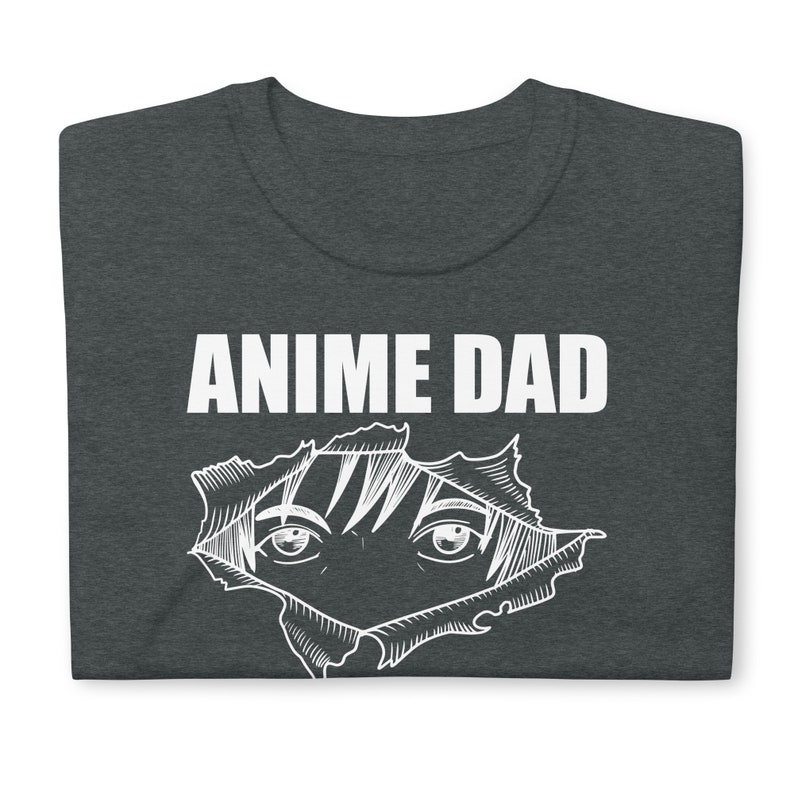 May include: Dark grey t-shirt with the text "Anime Dad" in white. A white outline of an anime character's eyes peeking out from a ripped hole in the shirt.