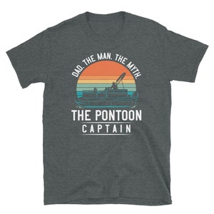 May include: A dark heather grey t-shirt with a vintage-style graphic of a pontoon boat on a sunset background. The text "Dad. The Man. The Myth. The Pontoon Captain" is printed in white on the shirt.