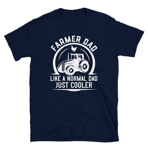 May include: Navy blue t-shirt with a white graphic of a tractor and the text "Farmer Dad Like a Normal Dad Just Cooler".
