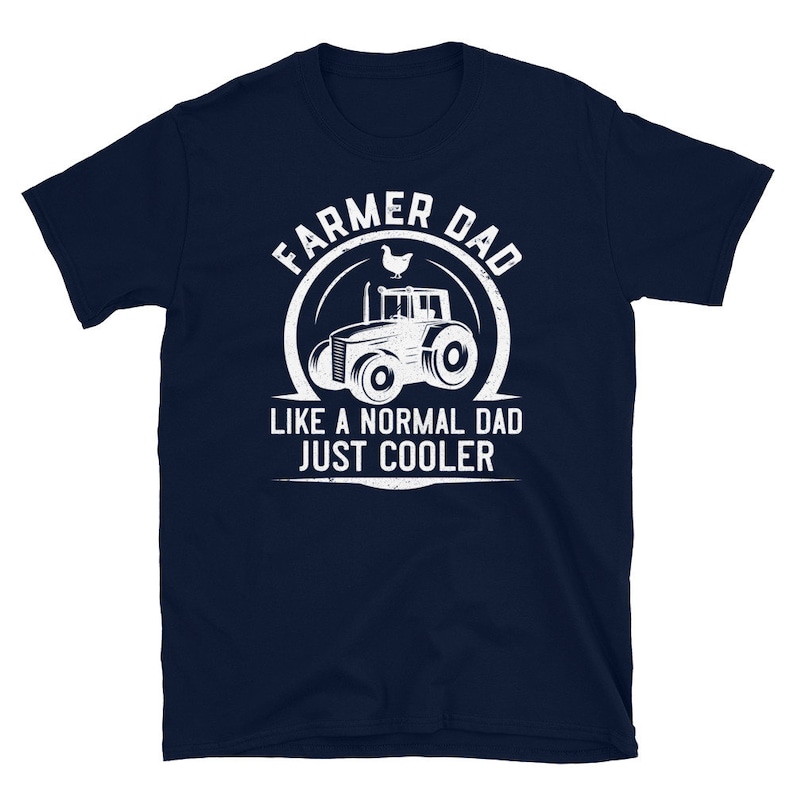 May include: Navy blue t-shirt with a white graphic of a tractor and the text "Farmer Dad Like a Normal Dad Just Cooler".