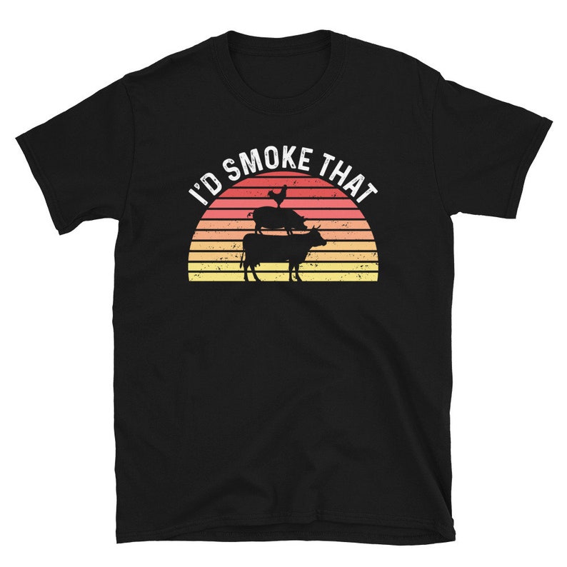 May include: Black t-shirt with a retro sunset graphic and the text "I'd Smoke That". The graphic features a chicken, pig, and cow stacked on top of each other.
