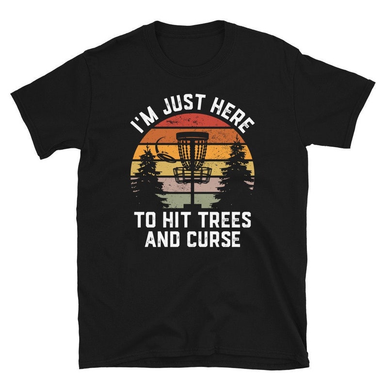 May include: Black t-shirt with a vintage-style graphic of a disc golf basket and the text "I'm Just Here To Hit Trees And Curse".