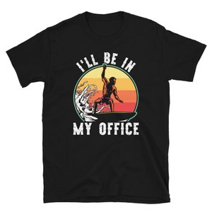 May include: Black t-shirt with a white graphic of a person surfing on a wave with the text "I'll be in my office".