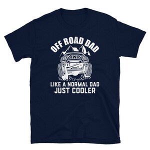May include: Navy blue t-shirt with a white graphic of an off-road vehicle and the text "Off Road Dad Like a Normal Dad Just Cooler".