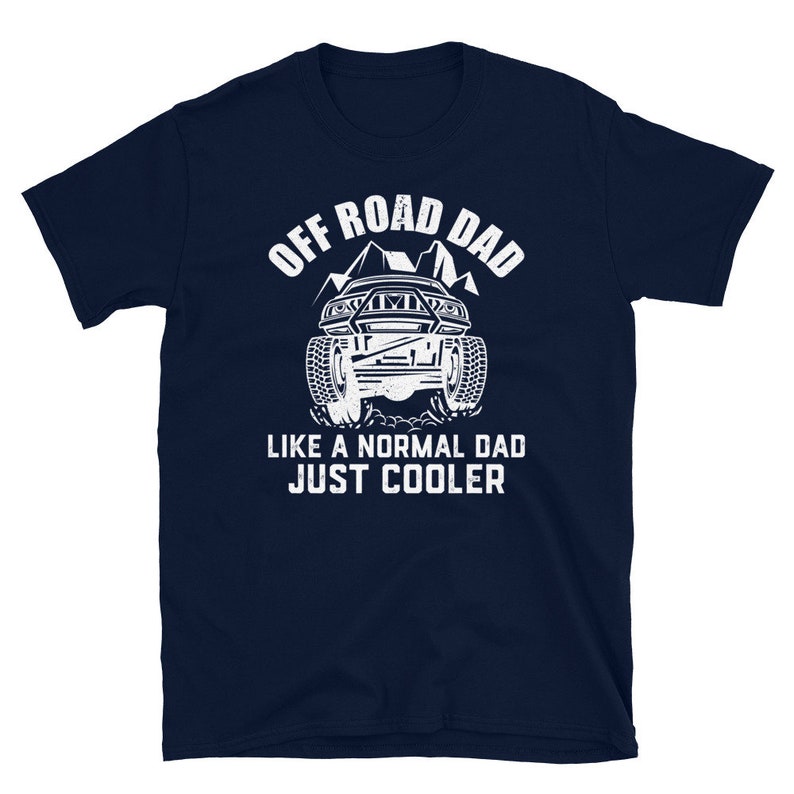 May include: Navy blue t-shirt with a white graphic of an off-road vehicle and the text "Off Road Dad Like a Normal Dad Just Cooler".