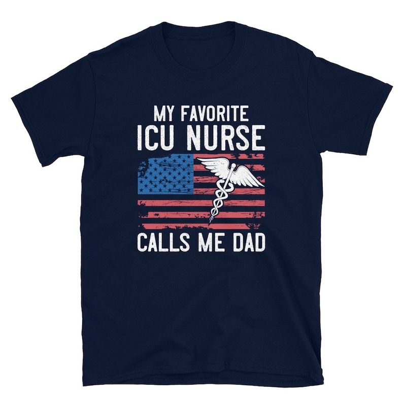 May include: Navy blue t-shirt with a white and red American flag design and the text "My Favorite ICU Nurse Calls Me Dad".