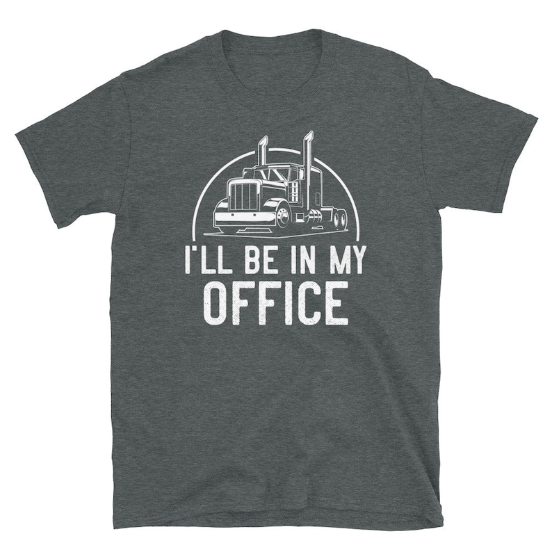 May include: A dark heather grey t-shirt with a white graphic of a semi-truck and the text "I'll be in my office".