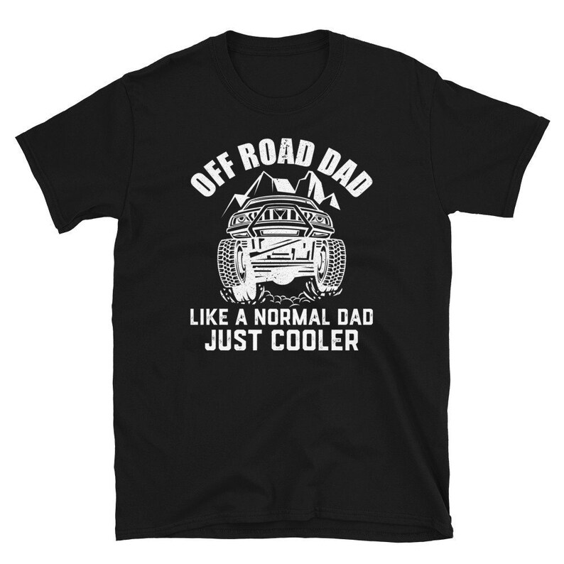 May include: Black t-shirt with white text that reads "Off Road Dad Like a Normal Dad Just Cooler". The shirt features a graphic of a white off-road vehicle driving through a mountain landscape.