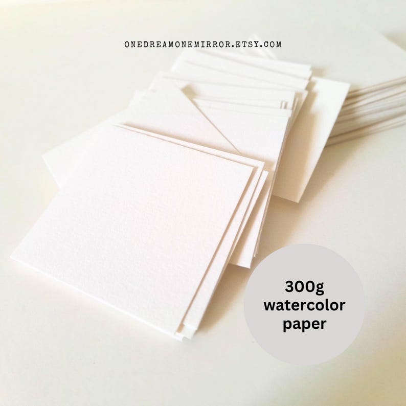 May include: A stack of square, white watercolor paper sheets. The paper is 300g and appears to have a textured surface. The Etsy shop URL is visible at the top. The paper is arranged in a neat pile, ready for use.