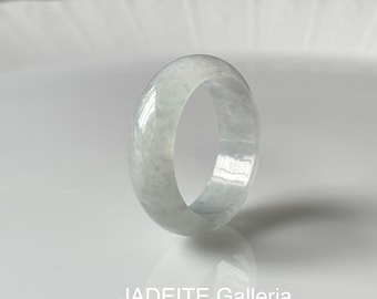 May include: A white jadeite ring with a smooth, polished finish. The ring is thick and has a rounded shape.