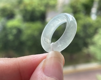 May include: A translucent white jade ring with a smooth, polished finish.