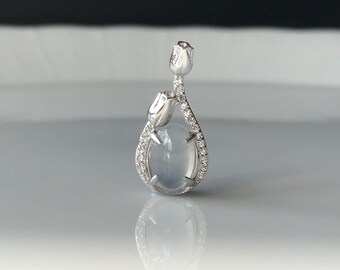 May include: A silver pendant featuring a teardrop-shaped white gemstone surrounded by a delicate silver rose design.