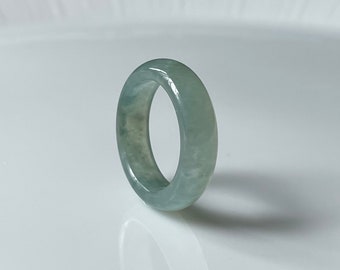 May include: A light green jade ring with a smooth, polished finish.