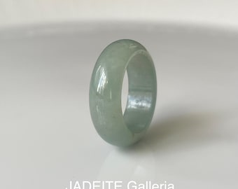 May include: A light green jadeite ring with a smooth, polished finish. The ring is thick and has a rounded shape.